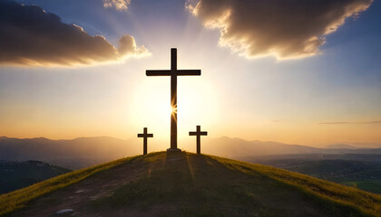 three crosses on a hill with the sun behind them