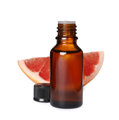 Bottle with grapefruit essential oil and piece of fresh fruit isolated on white