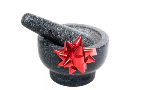 Cut out - mortar and pestle with a riboon rosette concept practical household gifts.