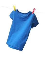 One blue t-shirt drying on washing line isolated on white