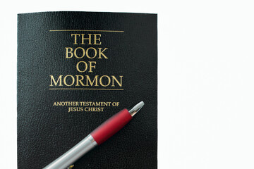 The Book of Mormon and red and silver pen resting on it highlight the connection between scripture...