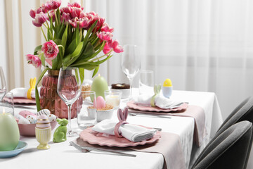 Festive table setting with beautiful flowers. Easter celebration