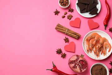 Natural aphrodisiac. Different products and paper hearts on pink background, flat lay. Space for text
