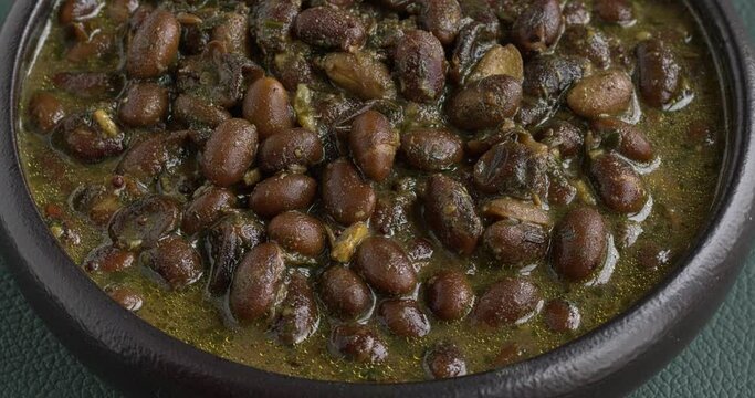 Black soybeans cooked in spices. Bhat ki Chudkani - a traditional dish of the Kumaon region. Table spin. 