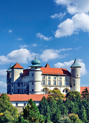 View on castle Nowy Wisnicz in Poland in sunny autumn day on a background of blue sky with white clouds