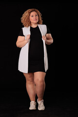 plus size blonde woman in photo studio on black background, curvy woman