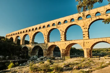 Fotobehang Pont du Gard illuminated ancient Roman aqueduct Pont du Gard near Languedoc, France, built as part of the infrastructure for water supply of the roman empire.