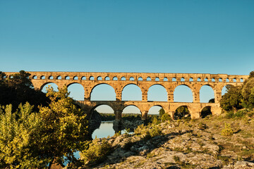 illuminated ancient Roman aqueduct Pont du Gard near Languedoc, France, built as part of the...