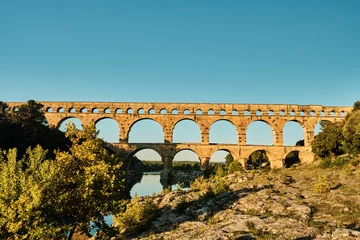 Selbstklebende Fototapete Pont du Gard illuminated ancient Roman aqueduct Pont du Gard near Languedoc, France, built as part of the infrastructure for water supply of the roman empire.