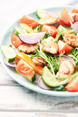 Healthy Salad with Chicken Breast, Cherry Tomatoes, Cucumber, Orange Pepper, Endive and Red Onion. Close up.	