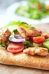 Pita bread with Chicken Breast, Cherry Tomatoes, Cucumber and Rocket. Close up.
