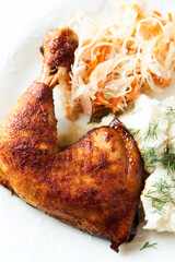 Spicy roasted chicken leg with mashed potatoes and raw salad. Bright background. Close up.	
