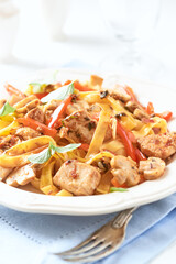 Pappardelle Pasta with chicken breast, red pepper and champignons. Bright background. Close up.	