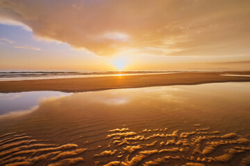 Atlantic ocean sunset with surging waves at Fonte da Telha beach, Costa da Caparica, Portugal - 765064679