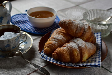 cup of tee and croissants on a table