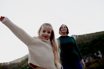 Mother and daughter walking in the nature