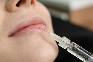 Client getting lips injection, closeup. Cosmetology procedure
