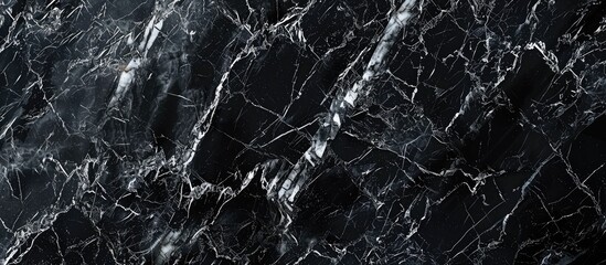 An up-close view of a dark black marble wall set against a solid black background