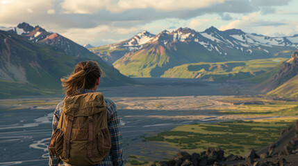 Hiker gazes at serene volcanic terrain, a harmonious blend of earthy tones and open skies.
