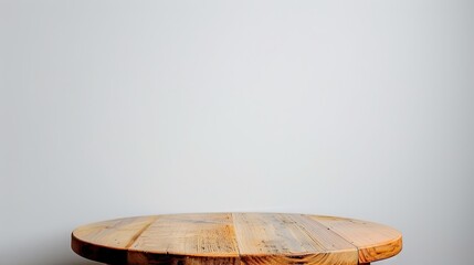 An isolated wooden round table sits against a white backdrop.