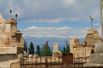 Grave yard at the shores of Issyk-Kul and Tian Shan Mountains, Kyrgyzstan