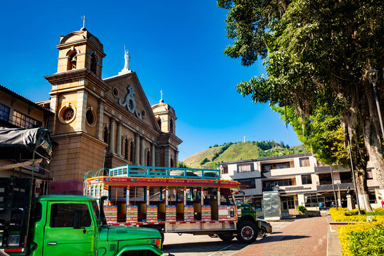 Colorful traditional rural bus from Colombia called chiva at the central square of the small town of Pacora in Colombia