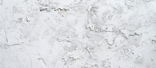 An old white wall displays multiple cracks and flaking paint, showing signs of wear and decay