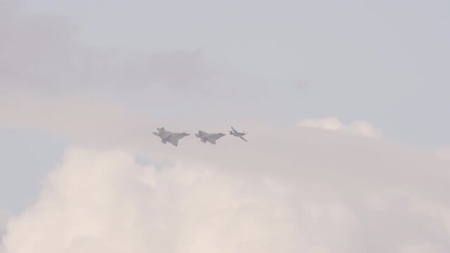 Panning Shot Of Fleet Of Fighter Airplanes Flying In Cloudy Sky - Huntington Beach, California