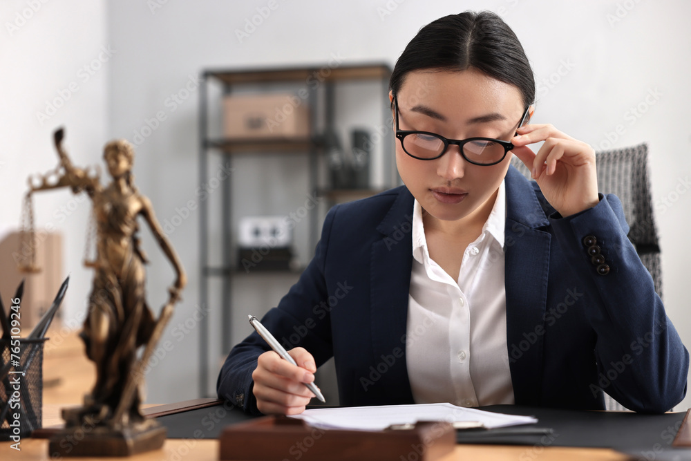 Wall mural Notary signing document at table in office