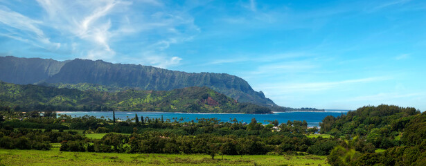Panoramic view of Hanalei Bay, Kauai, Hawaii. The crescent-shaped Hanalei Bay is one of Hawaii’s most scenic and pleasant beaches, set beneath a range of monumental mountain peaks.  - 765113658