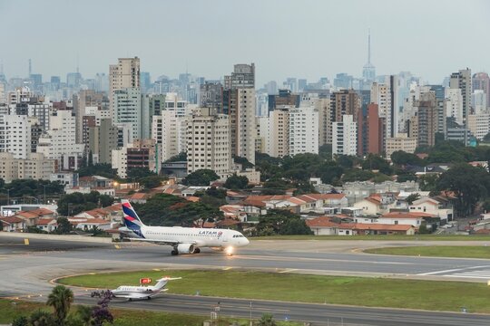 Airbus A 320 PR MHE from LAtam Airlines at Congonhas Airport. City of S&atilde;o Paulo, Brazil. Aircraft at the runway before takeoff in the late afternoon.