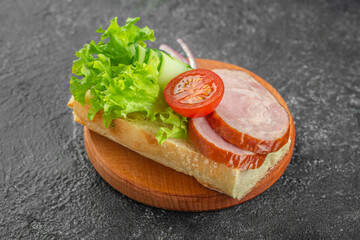 Ciabatta Sandwich with slices of smoked sausage, lettuce, fresh tomatoes, cucumber