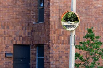 Curved traffic safety mirror on a Boston roadway, USA