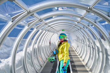 Snowboarder Walking through Tunnel to Slopes
