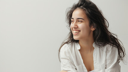 An image of a happy Woman in white clothes on a white background and Looking at the Camera. - Powered by Adobe