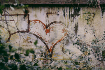 Heart graffiti on the wall of an abandoned house
