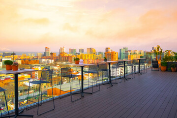 Luxury terrace view in the Barcelona district of Poblenou with the city skyline at sunset.