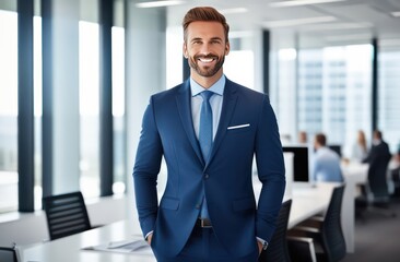Smiling confident young businessman looking at camera standing in office