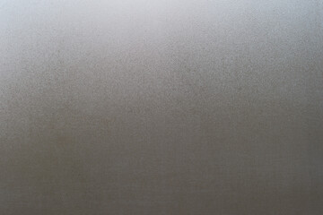 Water drops on fogged glass with a gray brightness gradient. Background