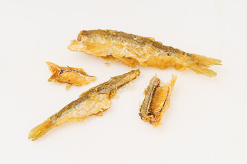 Fried small river fish on white background
