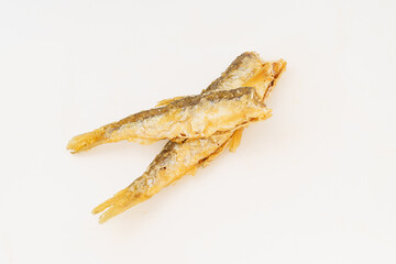Fried small river fish on white background