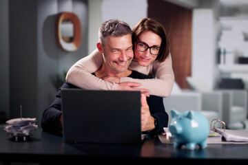 Happy Couple Doing Retire Finances Plan - 765153211