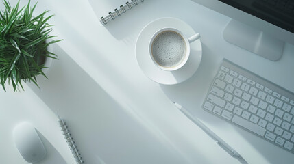 A cup of coffee sits amongst office essentials on a white desk.