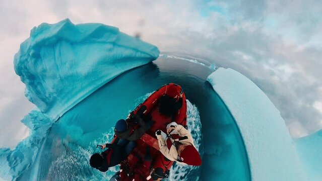 Antarctica explorers. Group of tourists explore icebergs near the Antarctica on their small inflatable speed boats