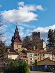 View of Châtelus (42140) rural village of Loire, iconic swiss-style bell tower built 1865 and castle dungeon, France