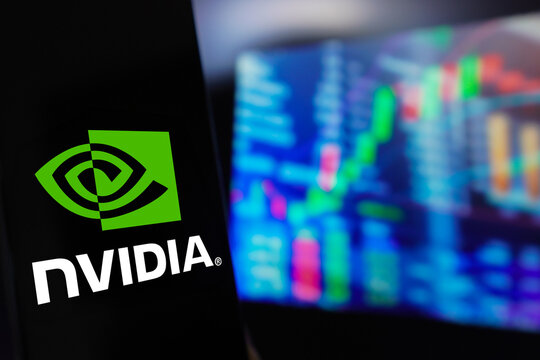 March 22, 2024, Brazil. In this photo illustration, the Nvidia Corporation logo is displayed on a smartphone screen, with a graphic representation of the stock market in the background.