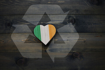 wooden heart with national flag of ireland near reduce, reuse and recycle sing on the wooden background. concept