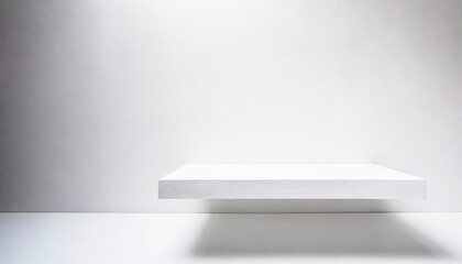 A white shelf with a white wall behind it. The shelf is made of wood with free space as a podium for product presentation