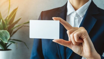 Obraz premium Businesswoman holding a Blank Business Card - Empty Business Card for Mockup - Template for Logo Design and Branding - Representation of Succesful Person
