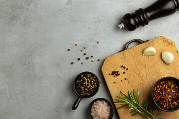 Empty Wooden Board, Salt and Pepper on Light Grey Concrete Background, Top View